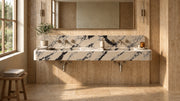 60-inch Calacatta Viola marble floating double sink in a travertine bathroom